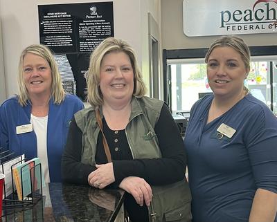 Three smiling staff at Peach State FCU
