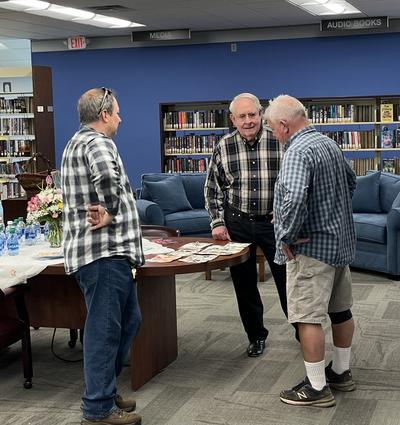 Three men viewing art