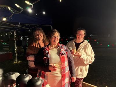 Main Street volunteers serving hot chocolate, Dec 2025
